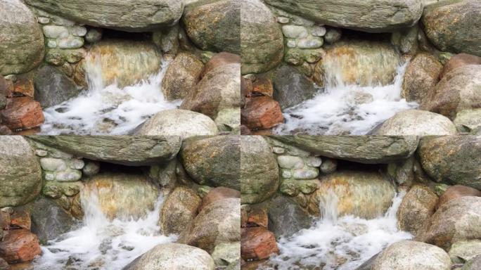 水流过岩石。石头之间的溪流