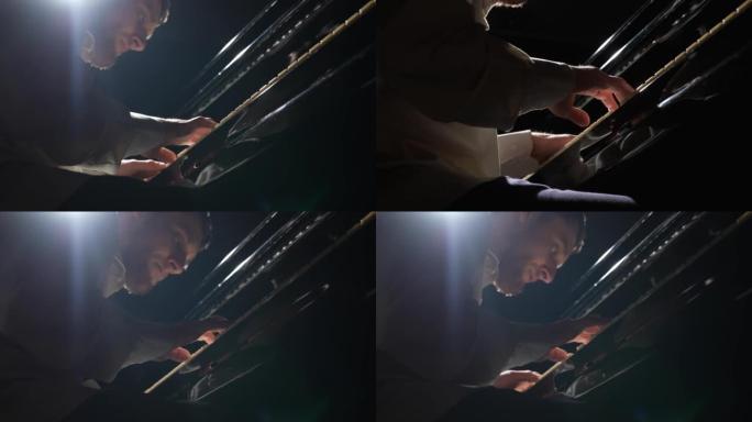 黑色背景上弹钢琴的人的低角度视图。钢琴家触摸乐器的黑白键。经典爵士音乐会。人的手靠近。以59.94f