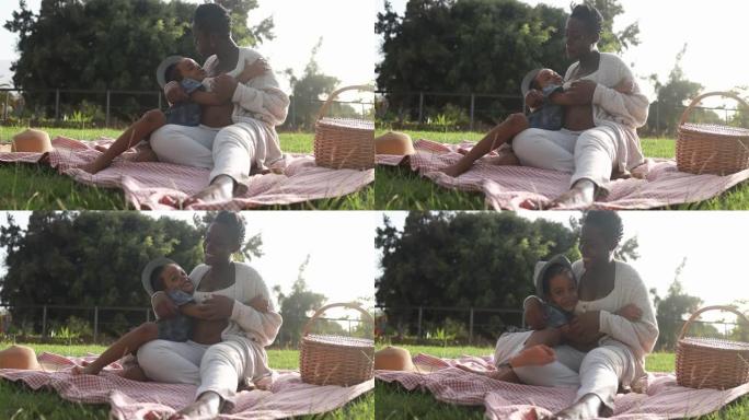 快乐的非洲怀孕母亲与儿子在公园度过温柔的时刻