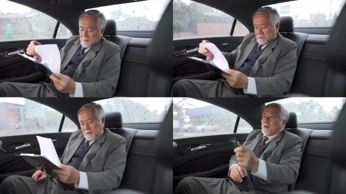 4k亚洲高级商人坐在汽车后座上写商业计划书