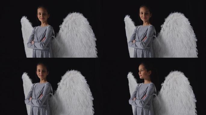 工作室拍摄肖像自信的女孩戴着天使翅膀
