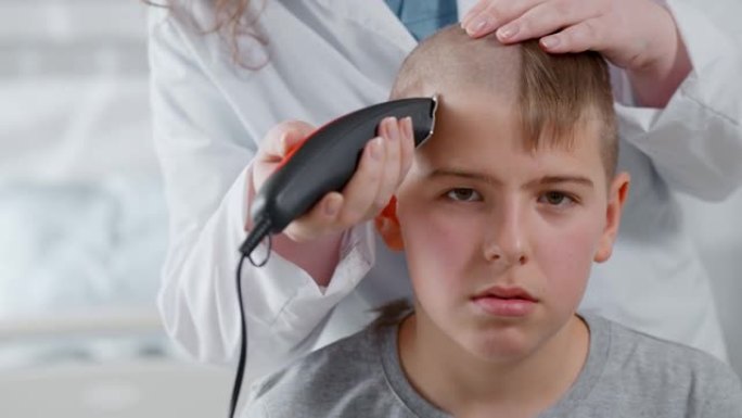 医生用理发推子剃光青少年男孩准备化疗