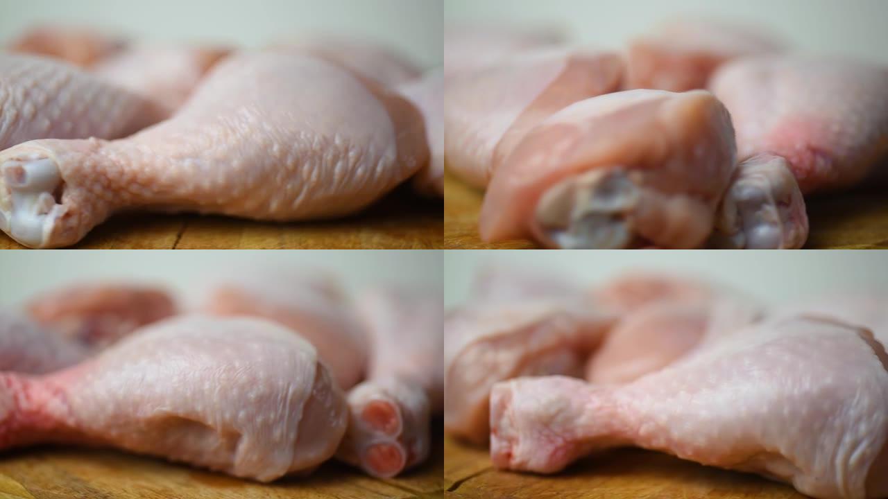 生的，新鲜的鸡大腿，在砧板上转成一圈。