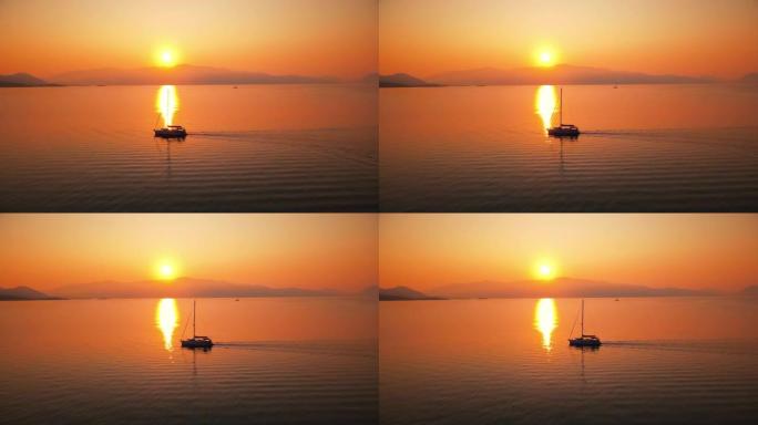 希腊爱奥尼亚海沿岸的日落。明亮的太阳，远处的陆地，漂浮的船，水中的倒影