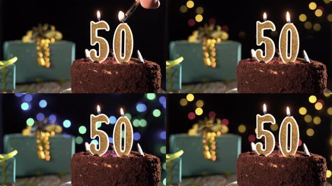 桌上甜蛋糕上的五十号生日蜡烛，五十岁生日。打火机上的火，吹灭节日蜡烛。