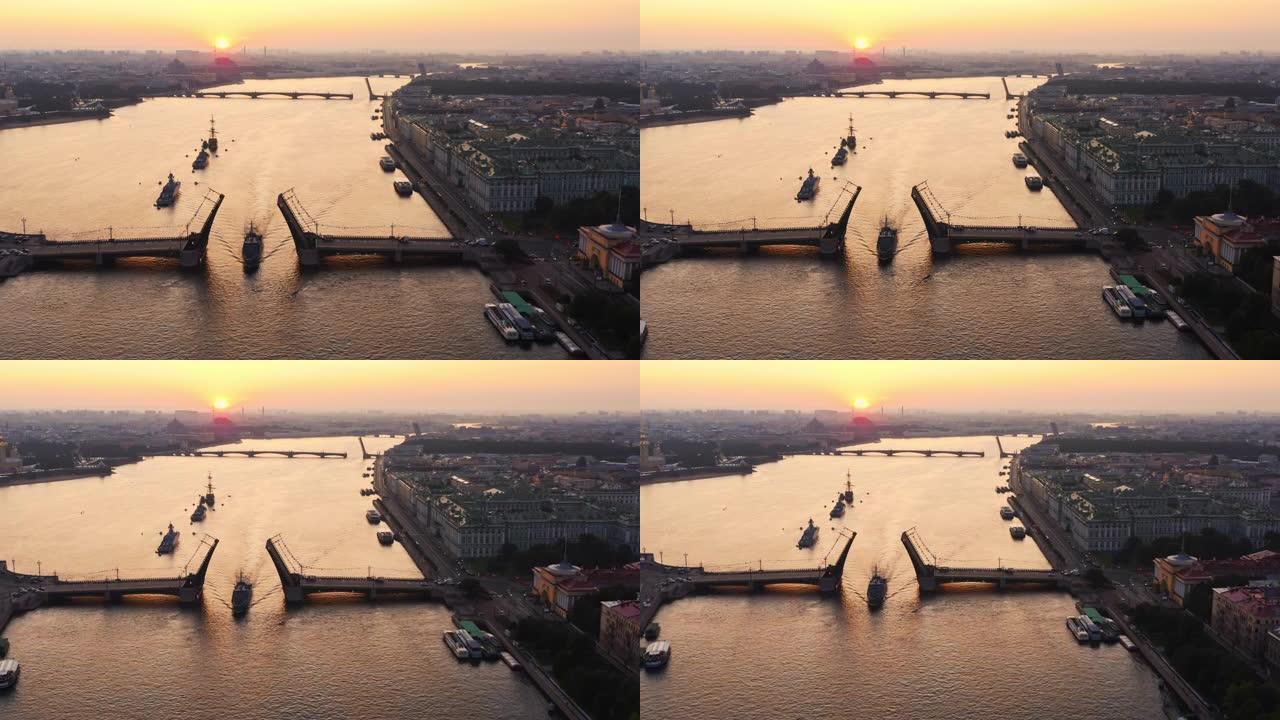 清晨，在俄罗斯海军节日之前，涅瓦河上的空中景象与军舰，军舰从一座升起的吊桥下通过，最新的巡洋舰在标志