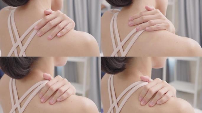 特写由于疼痛和疼痛，女性双手按摩肩膀。健康问题。