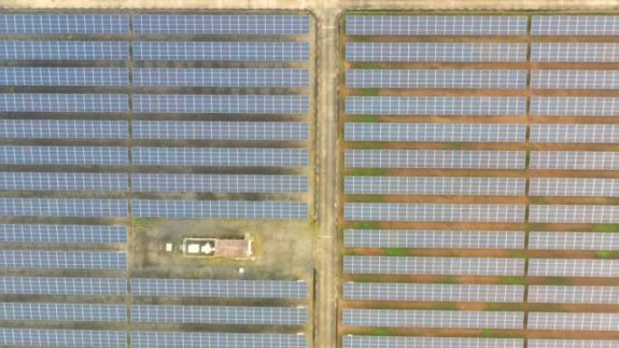 阳光明媚的春天日出时太阳能农场大型太阳能电池板的鸟瞰图。太阳能电池发电厂替代电源-概念