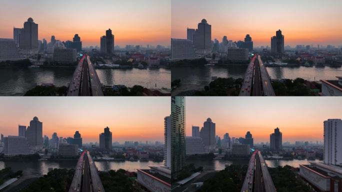 空中无人机在曼谷的超披亚河上的高速公路和地铁天空列车上的交通车灯的日出场景