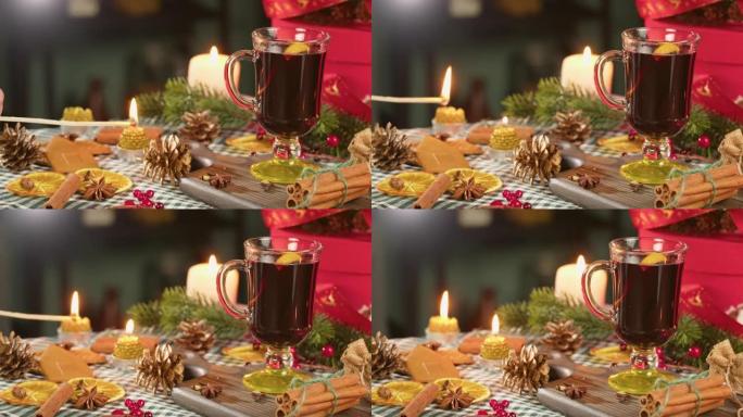 玻璃杯、谷胱甘肽和肉桂特写热酒。甜红葡萄酒配八角茴香，装饰松果点燃蜡烛。传统的冬季饮料。圣诞假期和新