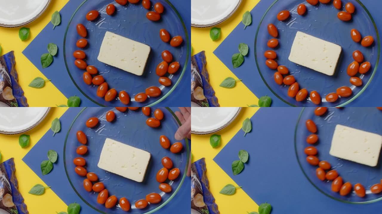 垂直平放视频: 厨师在烘烤前将羊乳酪和樱桃番茄放在一起