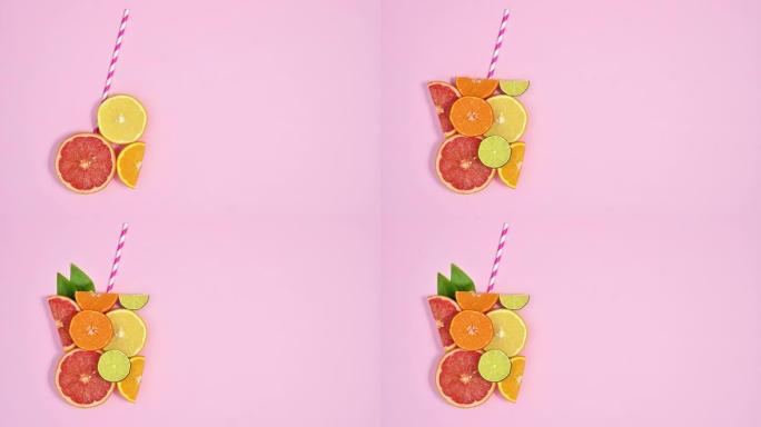 柑橘类水果使果汁玻璃的形状与稻草在柔和的粉红色主题的左侧。停止运动平铺