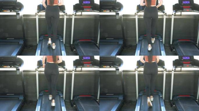 在健身馆的跑步机上跑步的女性运动脚。在跑步机上锻炼的黑色鞋子的后视图。运动俱乐部的低视野运动鞋训练。