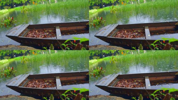 4K实拍，春雨中公园里湖中废弃的小船。