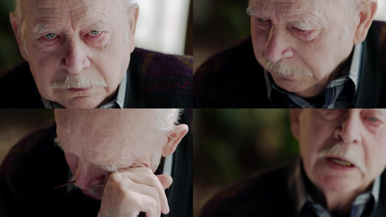 悲痛欲绝的老人，红边的眼睛看着相机，然后用手擦干眼泪