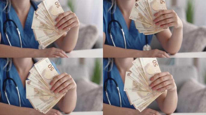 昂贵的医疗保健有钱的医生挥舞着钱扇