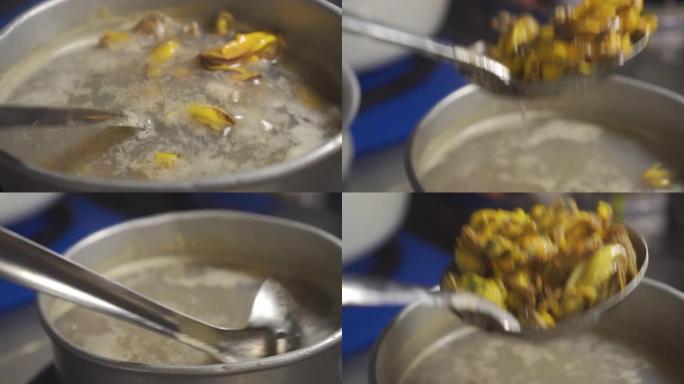 有人从沸腾的锅里得到贻贝。准备做海鲜。泰国菜。