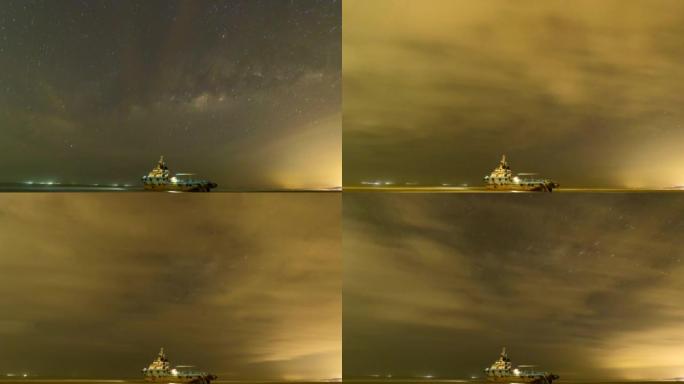 低潮期间搁浅的船在岸上的延时镜头，银河系背景。镜头在弱光环境下拍摄时包含噪音和纹理