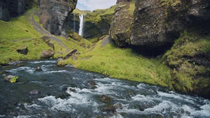 冰岛美丽的Kvernufoss瀑布。幽静山沟中山河的多彩景象。自然美概念背景。
