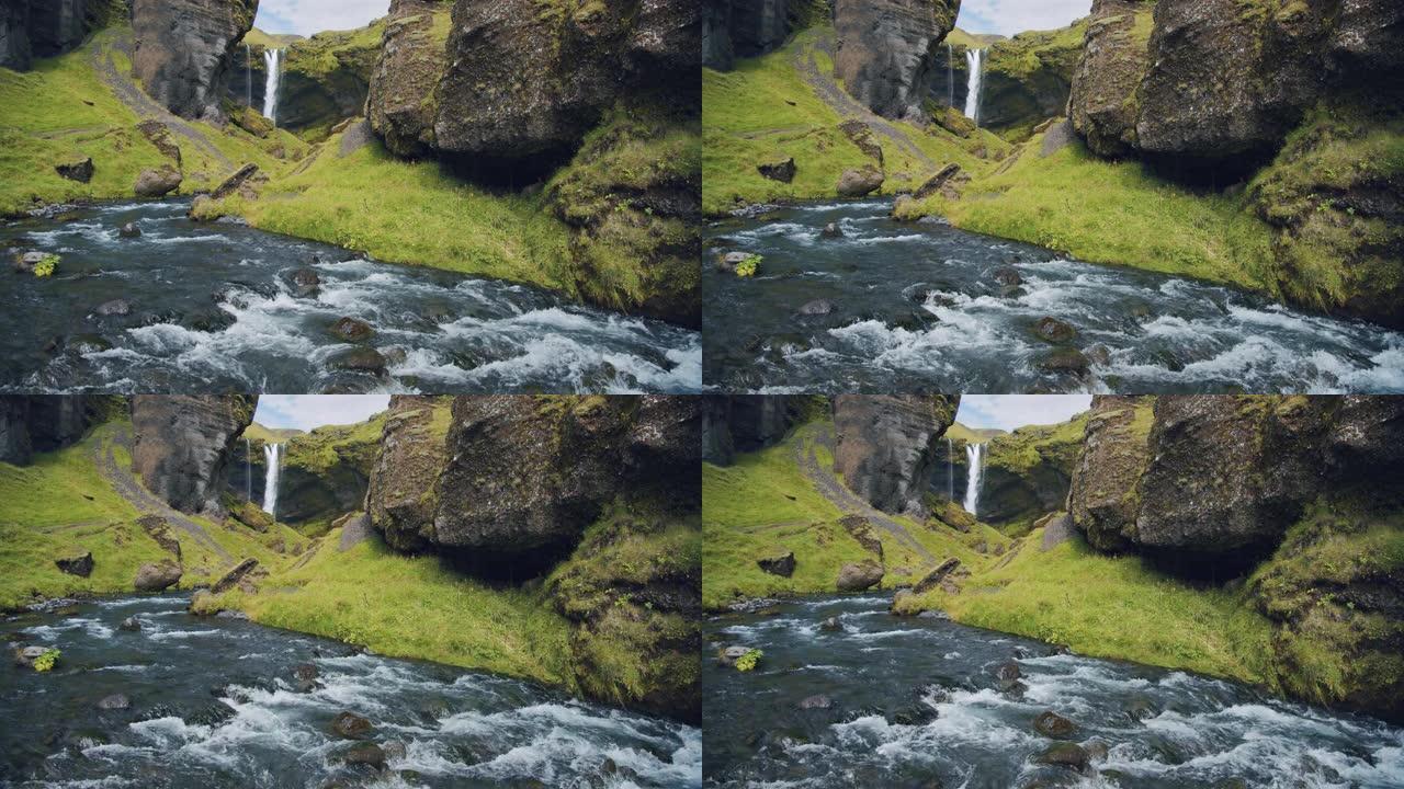 冰岛美丽的Kvernufoss瀑布。幽静山沟中山河的多彩景象。自然美概念背景。