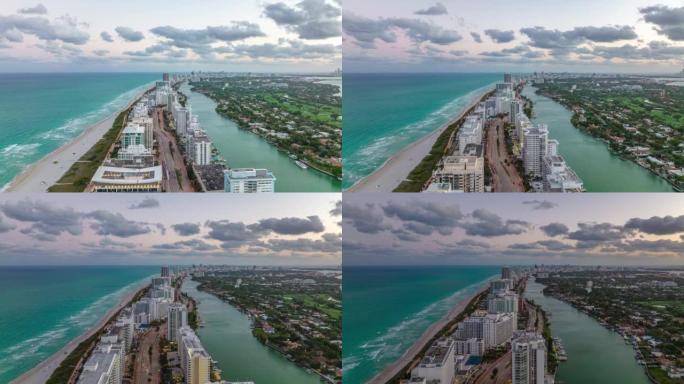 向前飞过海边一排高楼。黄昏时分，沿着多车道的酒店或公寓楼的照片。美国迈阿密