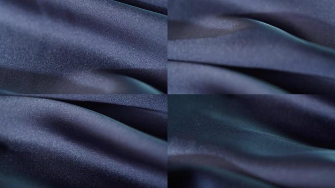 真丝蓝色面料特写。缝纫服装的布料质地。纺织品的宏观拍摄。针线活和定制。