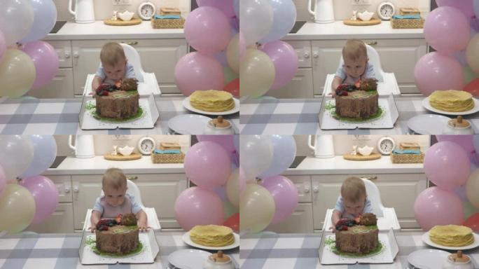 婴儿庆祝第一个生日假期，可爱的小孩试图到达蛋糕，一岁的孩子在他的第一个生日聚会上面对五颜六色的气球。