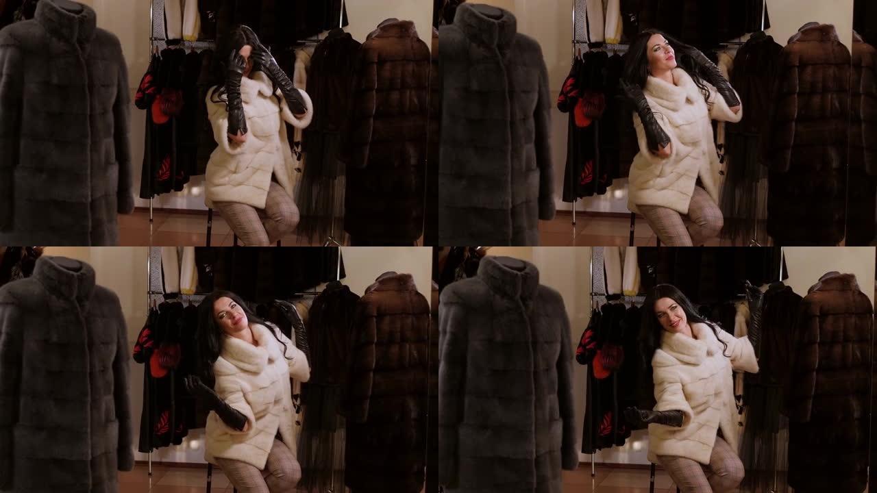 服装店里一个穿着新貂皮白皮大衣的幸福女人的肖像。