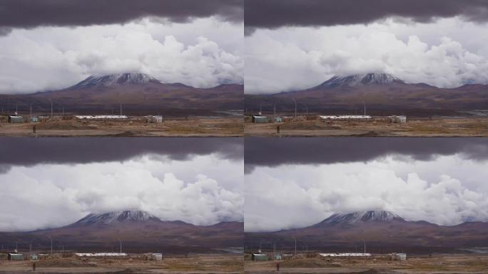 多云天气下火山峰附近的一个小居民点的景色