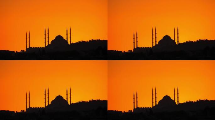 太阳升起之前，卡米卡清真寺的轮廓映衬在橙色的天空下