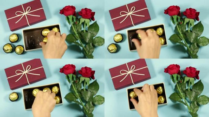 女人将金色优质巧克力糖果放入带有红玫瑰花朵的礼品盒或礼品盒中，为情人节做准备，节日概念