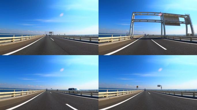 在东京Aqualine高速公路上行驶。车窗上的大海