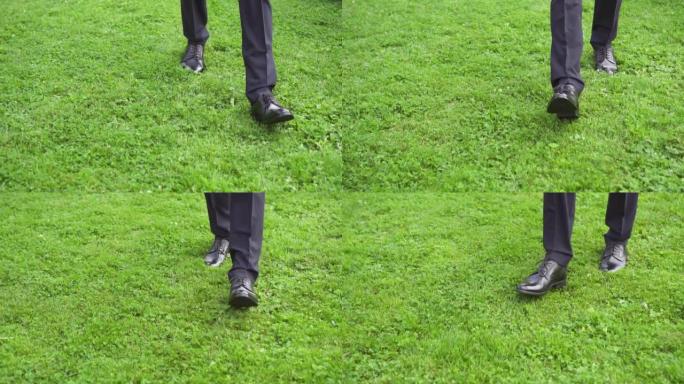 穿着时尚鞋子的男商人的脚在绿草丛中缓慢行走