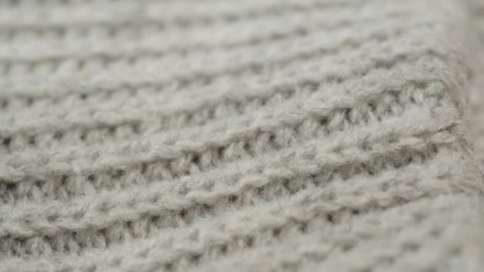 灰色针织布，浅灰色羊毛衣服面料特写，编织纺织背景