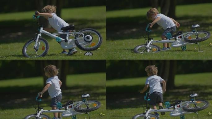 一个小男孩推着自行车掉到地上