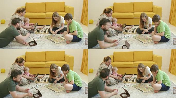 父母和孩子在地板上休息和做各种活动的大角度，同时在家里检疫期间一起度过时间
