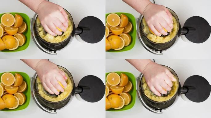 女人用榨汁机手工制作橙汁