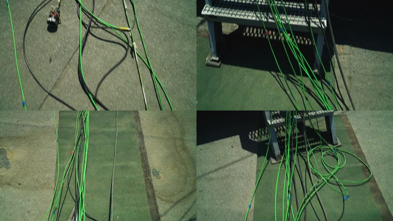 摄像机通过绿色、黑色和红色电缆移动。
