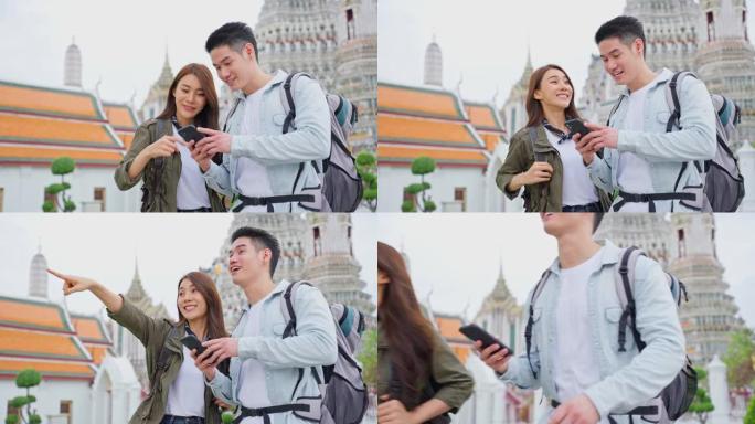 亚洲迷人的浪漫情侣在城市里度蜜月旅行。新婚姻男女背包客游客使用手机寻找目的地，一起享受假期。