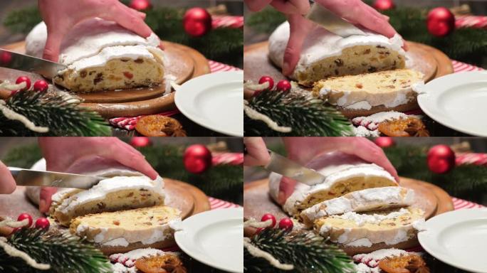 女人用杏仁饼和干果切成传统的圣诞蛋糕