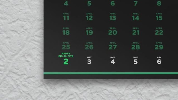 黑色美丽的挂历页面的特写，其中包含斋月斋戒日的时间表2022，相机移至开斋节日期，标记为绿色