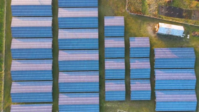 大型可持续发电厂的鸟瞰图，带有成排的太阳能光伏板，用于生产清洁的生态电能。零排放概念的可再生电力。