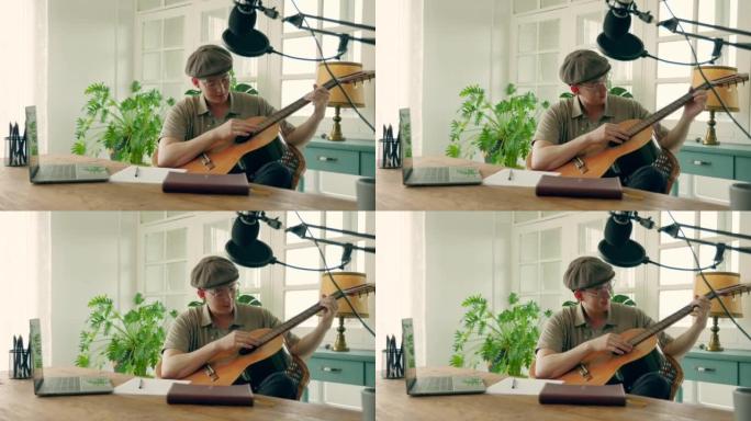 音乐家在创作新歌的同时弹吉他并在记事本中写歌词