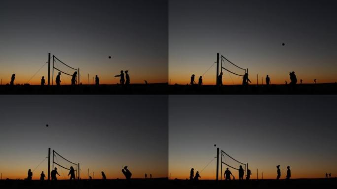 日落时沙滩球场上的排球网剪影，加利福尼亚海岸的球员。