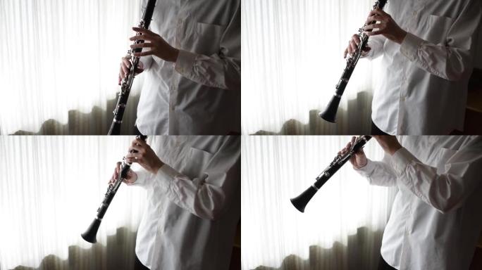 年轻美丽的女士，在家里玩单簧管，在窗户旁练习，享受音乐和空闲时间。