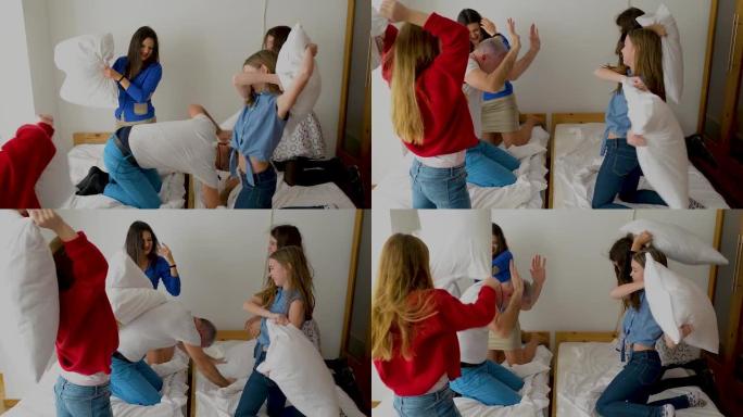 人，家庭和早晨的概念-与父母在家里的床上枕头打架的快乐孩子