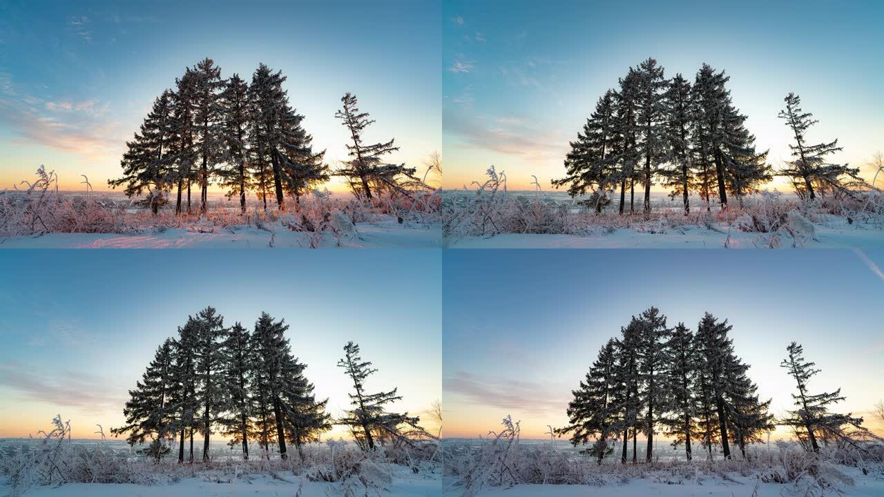 在冰冻的白雪皑皑的森林中，日落时天空中奇妙的颜色变化。冬季景观，延时4k