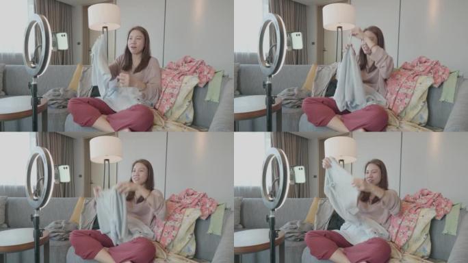 年轻的亚洲女性视频博客通过社交媒体展示服装直播，企业家生活方式
