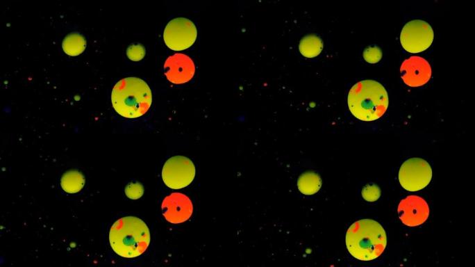 黑色背景上的圆形五彩球，银色亮片。红色和黄色颗粒随机移动。