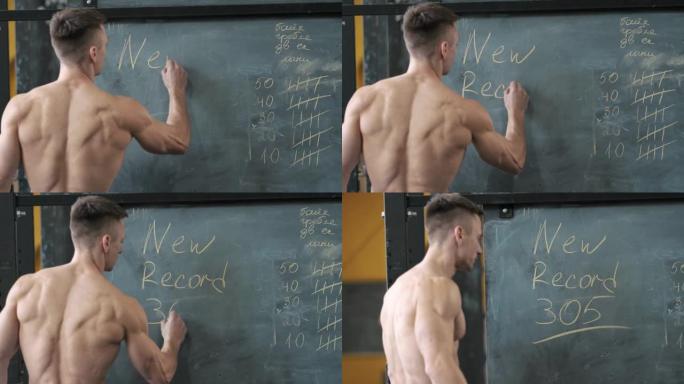 肌肉发达的运动员在健身房用粉笔在黑板上写字
